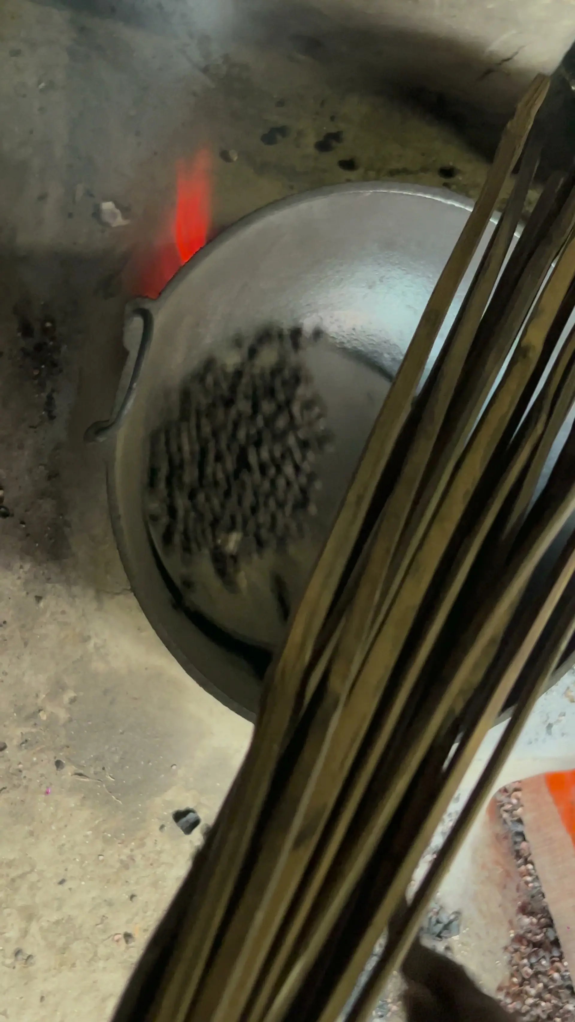 Raw makhana seeds roasting in an iron kadhai